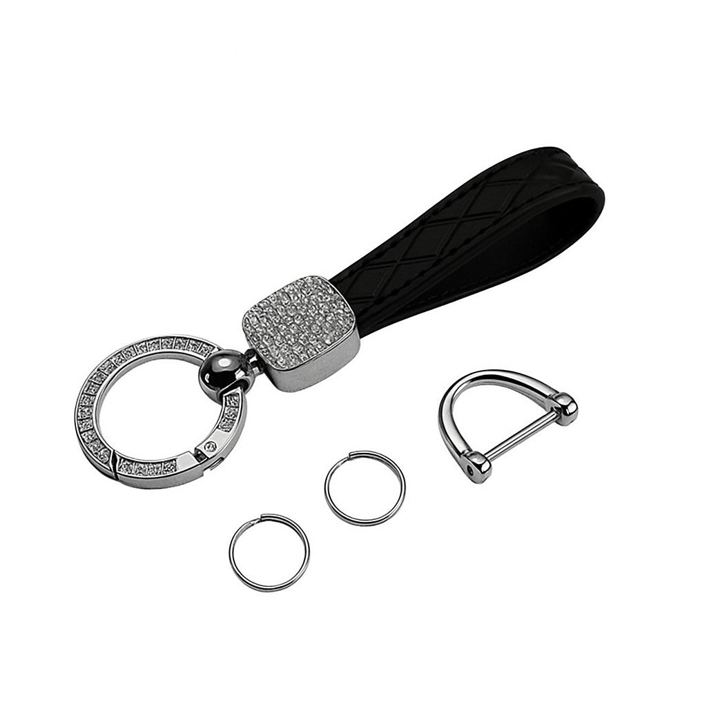 Keychain with black strap, silver keyring, and additional rings on a white background